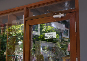 Sign Sorry, we are closed on the door of the store