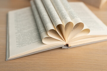 Open vintage book on wooden table. Education background. World books day