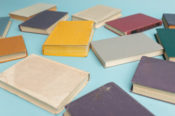 Old books on light blue table, top view. World Book Day background