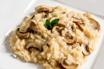 Risotto with mushroom on white plate.