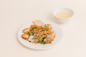 Banh Cuon. vietnamese steamed rice rolls with minced meat inside and fish sauce, Vietnamese food isolated on white background, perspective view
