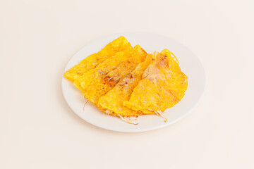 Banh xeo, Vietnamese Crêpes or Pancakes with pork, shrimp, onions, beasn sprouts inside, Vietnamese food isolated on white background. perspective view