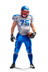 Sport. An American football player stands and holds a ball in his hand. Isolated on white background