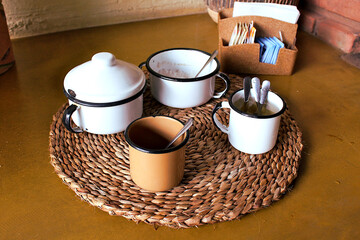 Things from the roça pot of coffee over a wood stove on fire and embers on firewood.