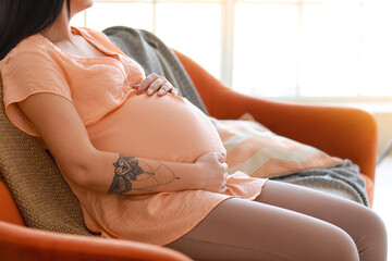 Young pregnant woman resting at home