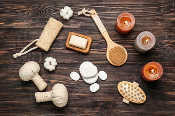 Fototapeta na wymiar Bathing supplies with spa stones and aroma candles on wooden background