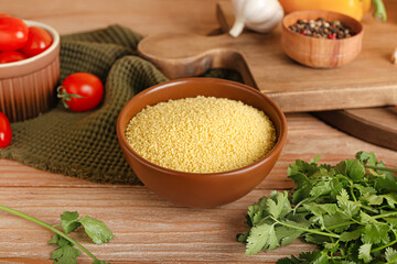 Bowl of raw couscous on table
