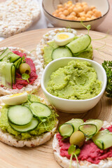 Tray with crispbreads and tasty hummus, closeup