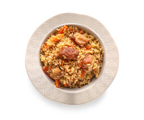 Bowl with tasty Asian pilaf on white background