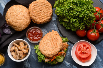 Fresh doner kebab in bun and ingredients on color background