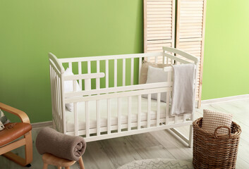 Stylish white crib in interior of modern children room
