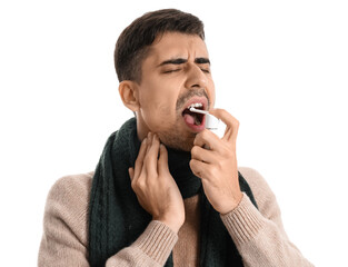 Ill young man with inhaler isolated on white
