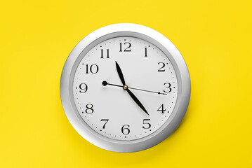 New modern clock on yellow background