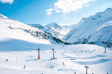 Skilift and drag lift on snow covered landscape. Winter sports at beautiful mountain range. Scenic...