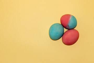 three eggs in pink blue painted easer eggs, a creative holiday concept