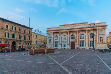 Sunrise view of Piazza del Popolo with Post Office palace and Neptune fountain in Pesaro, Italy