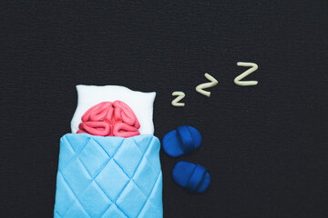 Plasticine pink human brain is sleeping. Mind rest concept.