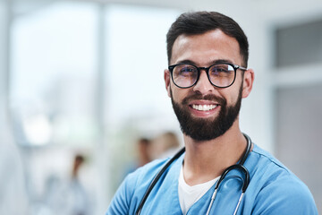 Ive found fulfilment in my profession. Portrait of a young medical practitioner standing in a...