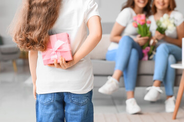 Little girl greeting her family for International Women's Day at home