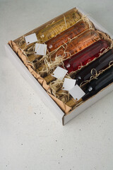 Assortment of 250 ml bottles of red, pink, white wine in box of wooden shavings, no label. Set of...