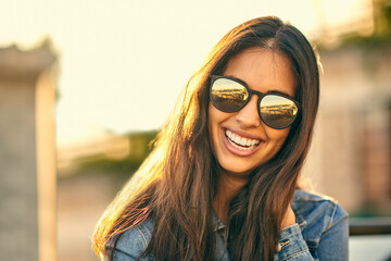 Sun is out, sunglasses on, ready to have fun. Portrait of an attractive young woman spending the...