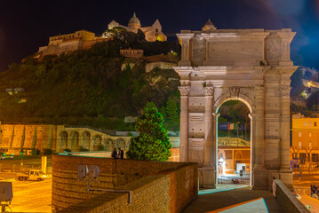 Night view of cathedral of San Ciriaco behind Arco di Traiano in Ancona, Italy