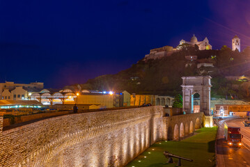 Night view of cathedral of San Ciriaco behind Arco di Traiano in Ancona, Italy