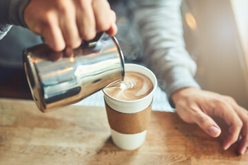 One perfect blend coming right up. Closeup shot of an unrecognizable barista pouring milk into a...