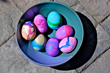 Bowl of colorful Easter eggs with modern art theme in ceramic bowl 
