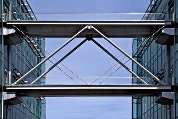 Skyway between buildings with inverted V brace for structural stability 