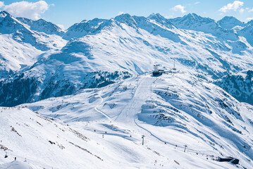 Fototapeta na wymiar Scenic view of snow covered mountain range. Ski station amidst beautiful white landscape. Beautiful alps during winter.