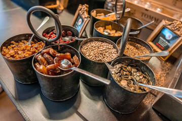 Dry fruits in container. Various seeds served on table. Nutritional food at luxurious resort.
