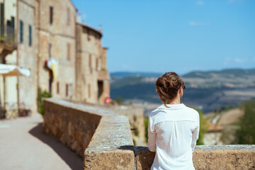 Fototapeta na wymiar Seen from behind trendy solo traveller woman in Tuscany, Italy