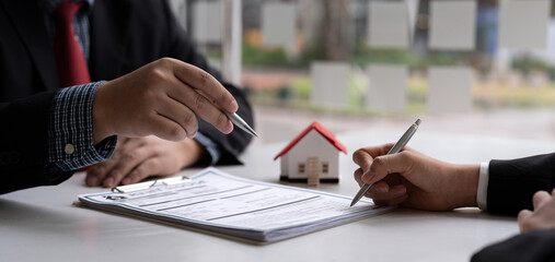 Real estate agent and customer signing contract to buy house, insurance or loan real estate.rent a house,get insurance or loan real estate or property