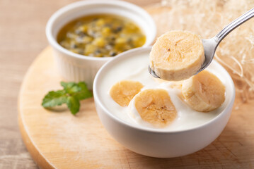 Yogurt with banana in bowl eating by spoon, Healthy food