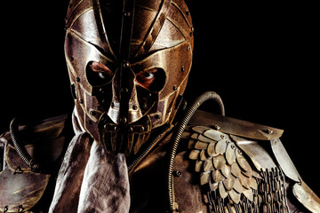 Photo of post apocalyptic wasteland warrior portrait standing in armor mask and outfit on black...