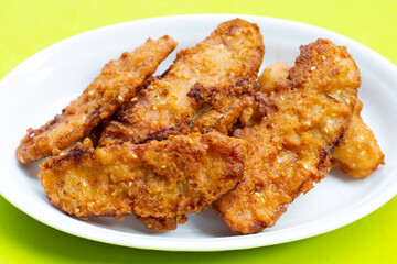 Fried bananas on green background.