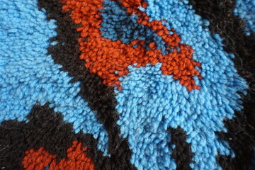 Black, Rust and Blue Abstract Latch Hook Design as Background