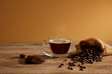 A closeup view of coffee decorated with coffee pack in wooden background for advertising 