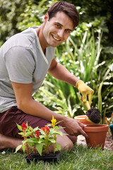 Fototapeta premium Gardening can be so relaxing. Portrait of a handsome young man gardening outdoors.