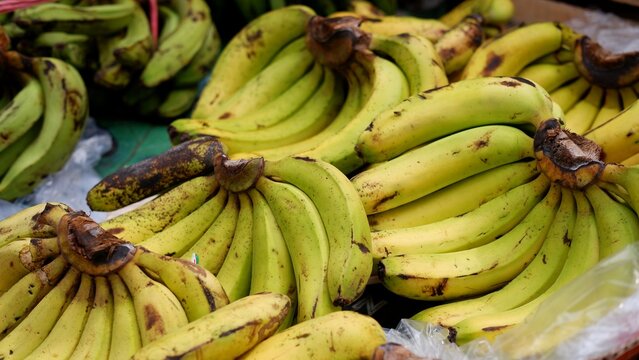 Stacks of ripe banana fruit in traditional market 