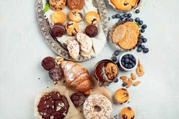 Dessert table with all kinds snacks on light background.