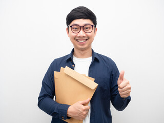 Man wearing glasses holding document envelope smiling thumb up