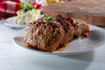 A view of a plate of sliced meatloaf.