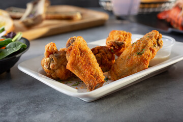 A view of a plate of cajun spice chicken wings.