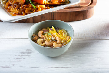 A view of a Thai mango papaya cashew salsa in a bowl.