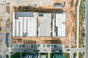 aerial top view of new parking garage under construction in city residential area