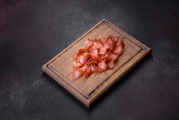 Snacks, jerky for beer on a black stone background