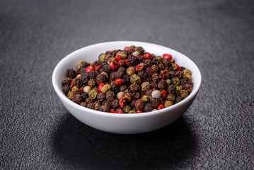Pepper spice with peas of three different colors in a white saucer
