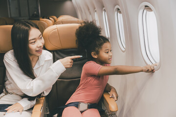 people with child kid happy looking window during air flight holiday travel